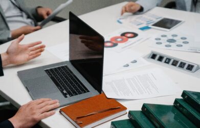 Researchers reviewing a scientific manuscript and data before submission
