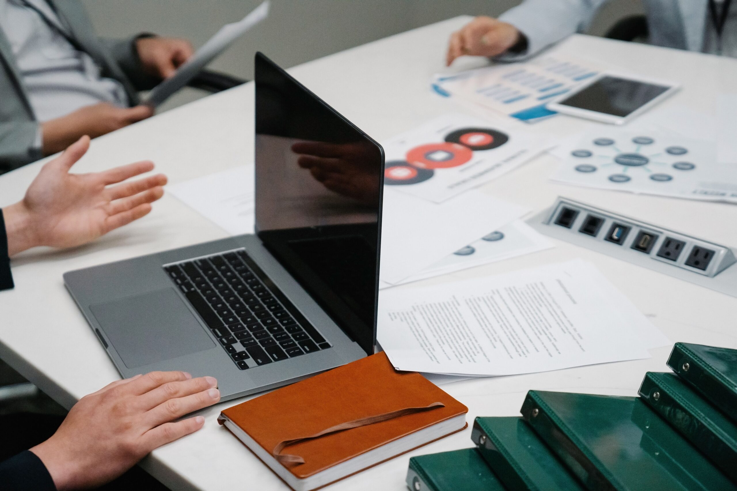 Researchers reviewing a scientific manuscript and data before submission
